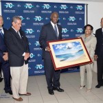 H.E. Governor Holiday receives a present from SXM managing Director, Regina LaBega. In photo looking on are, L-R: Gary Matser, Chairman of the Supervisory Board of Directors of SXM, Joe Peterson, Caretaker/Managing. 