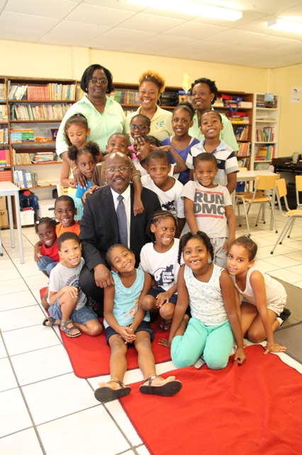 Prime Minister William Marlin being embraced by Students and Teachers of the Christian Hillside School after-school program after reading to them. 